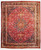 Full view of 9'6" x 12'6" Persian Mashad rug with burgundy field and navy floral medallion