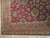 Corner detail of salmon rose border, ivory guard stripes and vegetable dyed wool pile