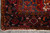 Fringe end and black border corner with cross medallion, coral and pink tribal figures