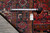 Tape measure and dealer tag on the rug back confirming size and tight foundation