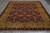 Traditional all-over floral wool rug photographed lengthwise with ivory cotton fringe at the near end