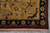 Corner detail with black floral outer band, gold border field and ivory cotton fringe