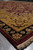 Perspective along the gold border corner showing wool luster and burgundy selvage finishing edge