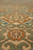 Pile-level macro of scrolling cloud hooks and an 8 petal rosette in rust