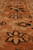 Rust border close-up with black outlined ivory star flowers and serrated leaf motifs