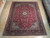 9'5" x 12' Persian Tabriz wool rug displayed on light hardwood floor showing full floral field