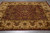 7'7" x 9'4" Indian wool rug on grey tile showing plum field and gold border