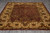 Full length view of hand-knotted Jaipur rug, ivory border framing a burgundy floral field