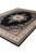 Diagonal perspective of the area rug with cotton fringe and multi-band ivory and red borders