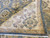 Back of the 8x10 Oriental rug folded over the ivory border, revealing even knotting