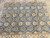 8'3" x 9'9" Oriental rug photographed overhead showing all-over rosette design and faint fold lines