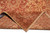 Folded corner revealing the tight hand-knotted wool weave and cotton foundation of the antique rug