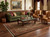 Traditional living room with green tufted sofa and black burgundy Oriental rug over walnut hardwood floor