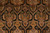 Detail of paisley boteh panels outlined in ivory pearl beading against jet black field