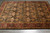 Angled view showing gold lattice panels, burgundy main border and lustrous natural wool pile