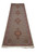 Angled floor view of the wool and silk Tabriz runner with rose pink floral border