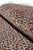Rolled edge close-up showing wool and silk pile sheen across the ivory herati lattice