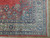 Corner detail showing ivory main border, navy guard stripes, floral spandrel and clean cotton fringe