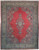 Antique red Persian Kerman rug with ivory floral border and navy diamond medallion, full overhead view