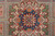 Central medallion detail with indigo core, ivory palmettes, green cartouches and orange rosette on gray