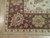 Corner detail showing brown border, ivory guard stripe, hand-tied fringe and low 3/8 inch wool pile