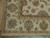 Corner detail showing layered guard stripes, ivory fringe and finely knotted wool pile of the rug