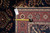 Back of the 7' x 9' rug with measuring tape and genuine hand woven Oriental rug tag
