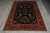 Full overhead view of the 7 by 9 Sarouk design rug on grey tile flooring
