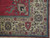 Corner detail of the ivory border with teal lotus palmettes and red tulip blossoms