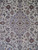 Close-up of the lobed center medallion, palmettes and curling vines on ivory wool pile
