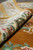 Rolled edge showing thick lustrous bamboo silk pile and multi-layer ivory border bands