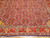 Angled floor view showing red palmette border meeting the all-over pattern of this large Persian rug