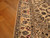Ivory main border with navy palmettes and rose blossoms photographed on a herringbone wood floor
