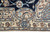 Border corner showing paisley roundel, lattice medallion and delicate floral motifs on a cream ground