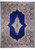 Full overhead view of 8'2" x 11'4" Persian Kerman rug with royal blue field and ivory medallion