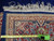 Reverse of 8x11 Kerman rug with tape measure, showing fine wool knot density and fringe