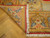 Folded back corner reveals dense hand-knotted weave, red selvedge binding and natural ivory cotton fringe