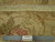 Reverse side of the 8 x 10 handmade rug beside a ruler confirming authentic hand-knotted construction