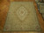 8 x 10 Chinese needlepoint rug displayed on parquet floor showing full Aubusson floral layout