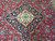 Ivory and pale blue center medallion set into navy ground with rose and green blossoms