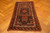 Vintage Kazak wool rug displayed on herringbone parquet floor showing triple medallion layout and zigzag borders