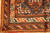 Corner detail showing running dog border, saffron guard stripe and dense hand-knotted wool pile
