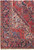 Indigo main border with rosettes and vase motifs beside the ivory corner spandrel