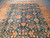 Overhead detail of the all-over floral repeat, cream vines and rust leaves on teal