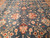 Teal blue field with soft abrash, pink palmettes and rust lanceolate leaves in wool