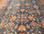 Close detail of wool pile showing blush rosettes, cream lattice and terracotta leaf sprays