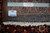 Back of the hand-knotted Persian wool rug with ruler, cotton warps and authentic handmade tag