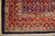 Corner detail showing tomato red main border, ivory guard stripes and white cotton fringe