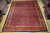 9'9" x 12'10" Persian Herati rug displayed flat on wood floor in rug warehouse