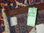 Reverse corner with green inventory tag reading 5538, cotton foundation and ivory wool fringe